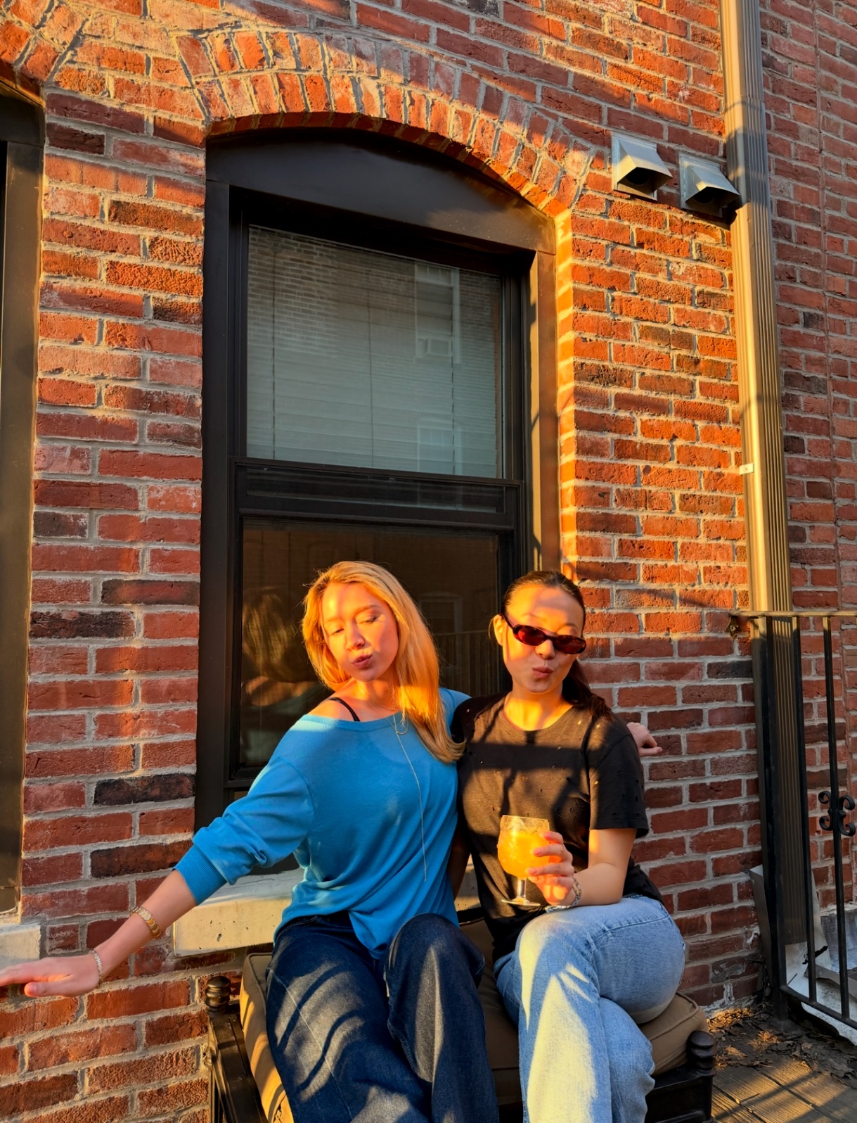 Kaitlyn and Joie on a Boston stoop in golden hour