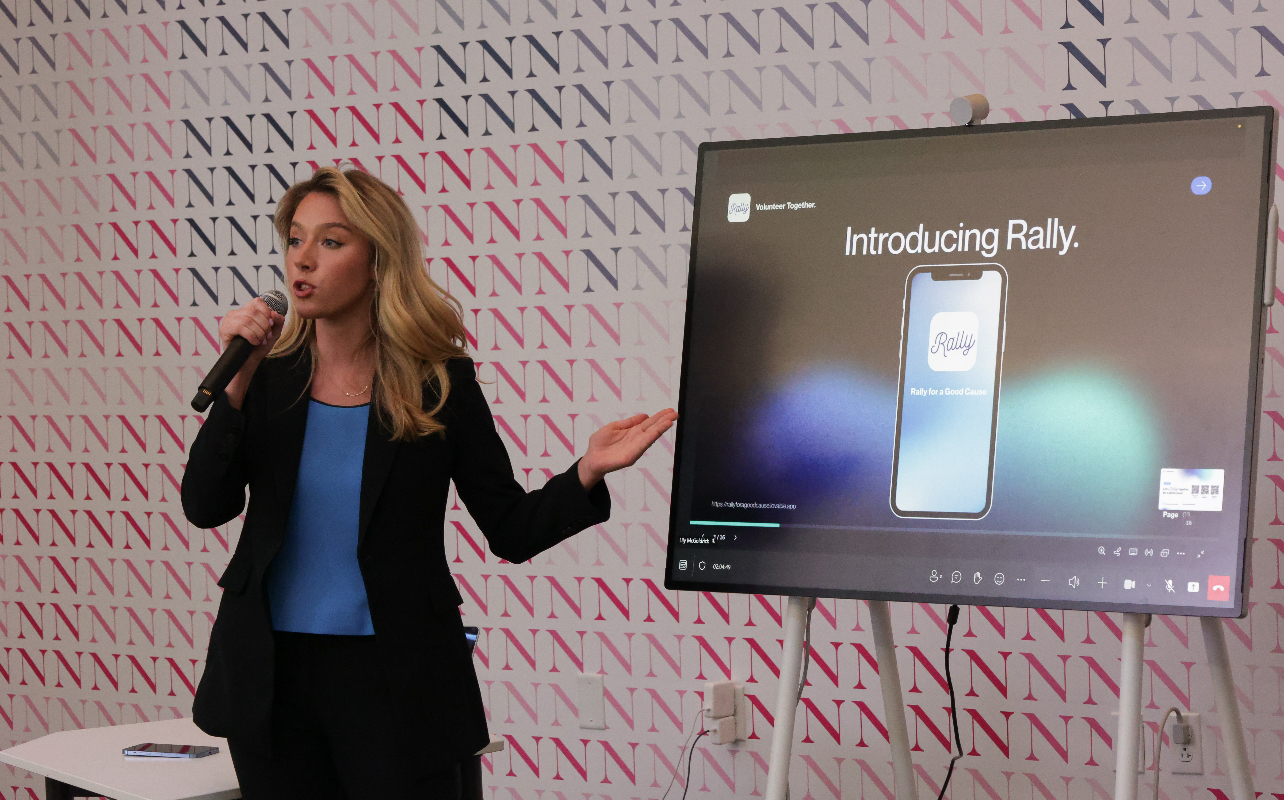 Kaitlyn pitching Rally on stage at a Northeastern event